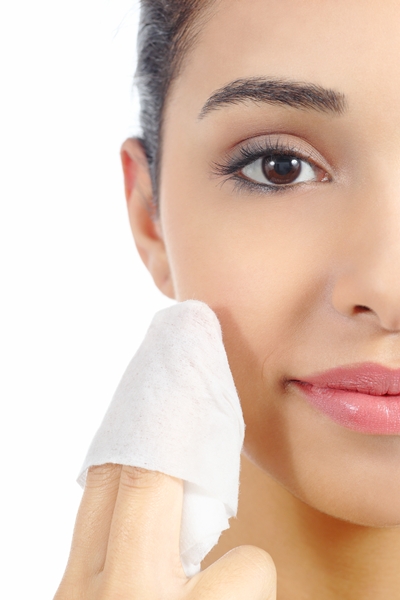 Close up of a woman face removing make up with a baby wipe